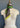 A vintage mannequin torso displaying a vibrant, multi-colored Be Still in Jade neckerchief tied around its neck, set against a muted gray background by At Home With Ray.