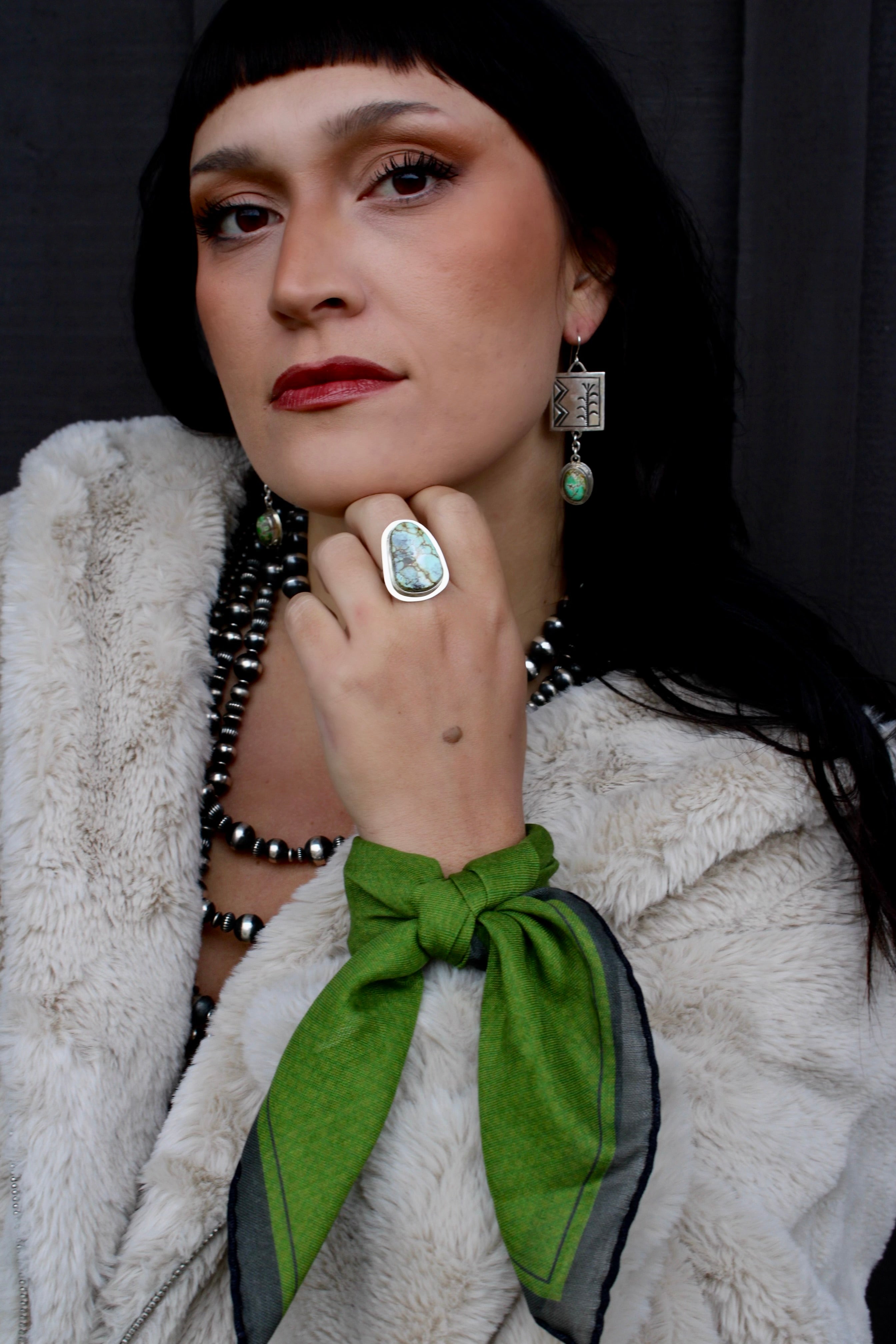 a luxury small silk wool neckerchief in vibrant green with charcoal border and hand rolled edges