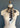 The Eden silk scarf in bone and sable, styled as a neckerchief on a dressmaker's dummy, showing the graphic snake print on one side and python print reverse.