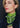 Woman wearing a retro patterned bandanna in bright green and navy blue