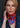 Woman wearing a retro patterned cotton silk bandanna in bright red and electric blue with white trim