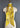 At Home With Ray Cactus Rose Silky Ribbon Scarf in Chamisa Flower golden yellow displayed on a dress form in a long elegant necktie style, showcasing the full illustrated southwestern design against the vibrant yellow ground.