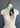A beige dress form showcases the Duos in Blue 56 silk scarf by At Home With Ray. The polka dot patterned scarf transitions in color from white to green and subtly incorporates a horse design. It has a black and white geometric border, tied loosely around the neck.