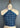 An elevated My Favorite Bandana in Indigo 66, styled as a halter top with white paisley patterns, is elegantly tied around the neck. The label reads "wolf form co n.y.c.