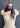 A display showcases "The Snowy Mustang" scarf by At Home With Ray, elegantly wrapped around a neck. The luxurious cashmere silk blend features a striking dual-color design: one side in deep burgundy and the other in light gray.