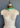 A vintage mannequin torso with light fabric cover displays a colorful silk Beginnings 68 bandana tied around the neck, featuring a vivid floral design on a green background. The mannequin is set against a gray At Home With Ray.